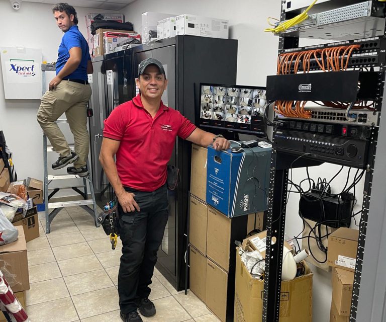 VezaTech IT technician performing computer maintenance and network setup at a client location in Miami.